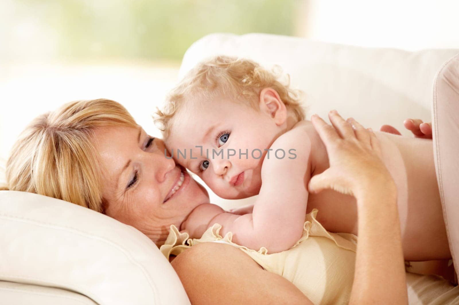 Baby, mother or holding for love on couch, care support or health wellness with parent happiness. Woman, young child or together with blonde hair, natural bonding or calm relax for growth development.
