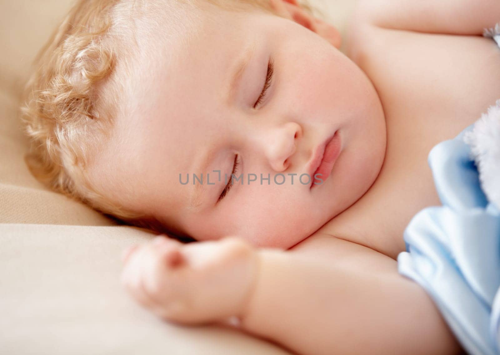 Sleeping, baby and infant closeup in bed with peace and rest in morning nap for growth or development. Child, sleep and face in bedroom, home or dreaming in crib with a blanket and sheet with comfort by YuriArcurs
