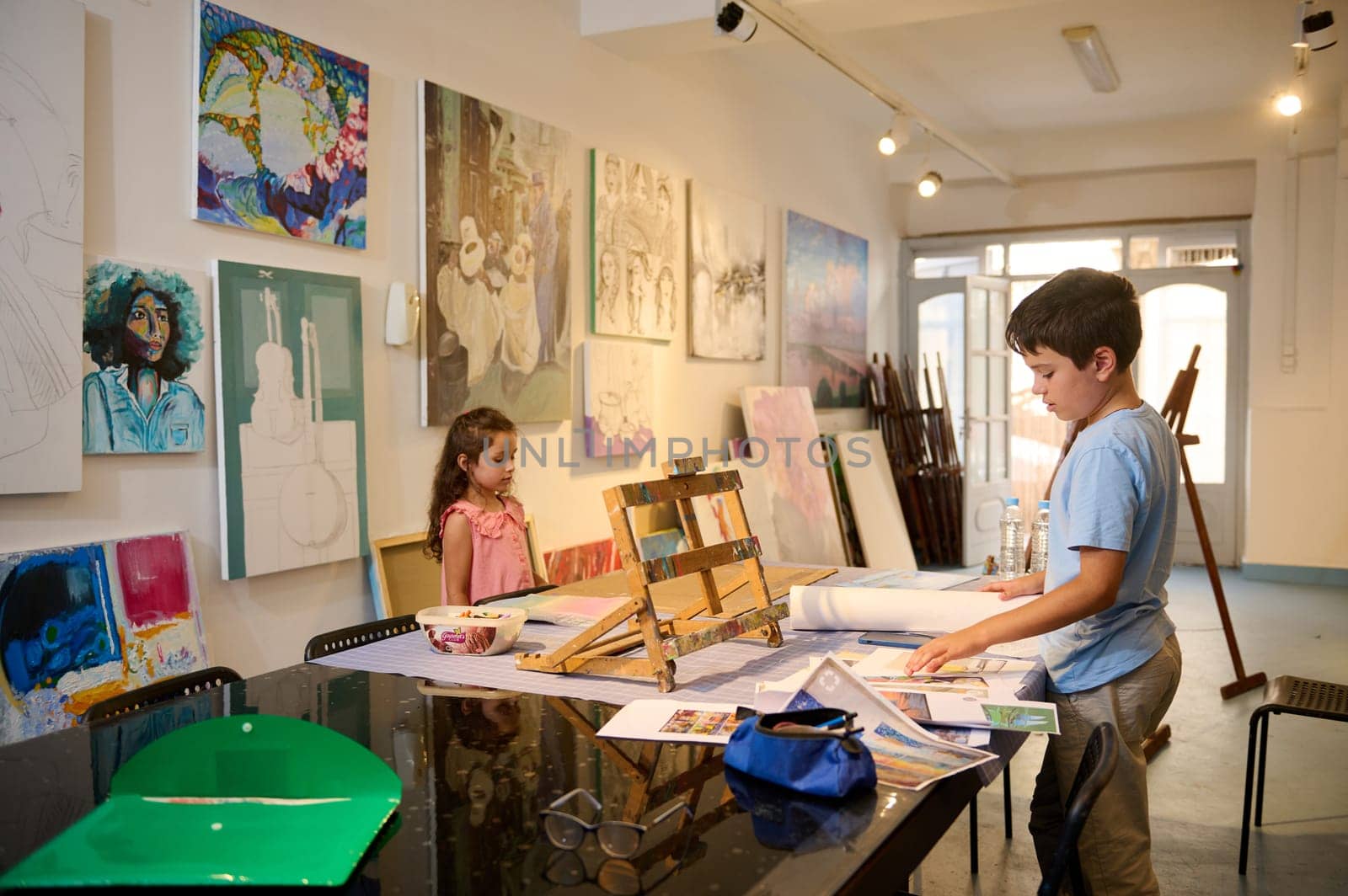 Adorable diverse kids learning painting and drawing at fine art class. People. Children. Education. Visual art concept by artgf