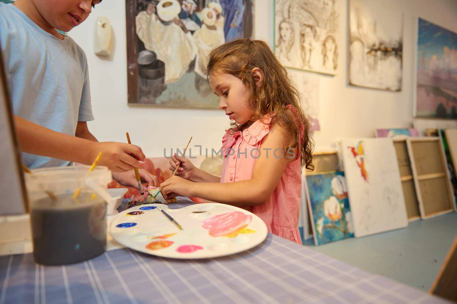 Adorable kids learn drawing in fine art gallery or creative workshop. Painting. Education. Elementary age school by artgf