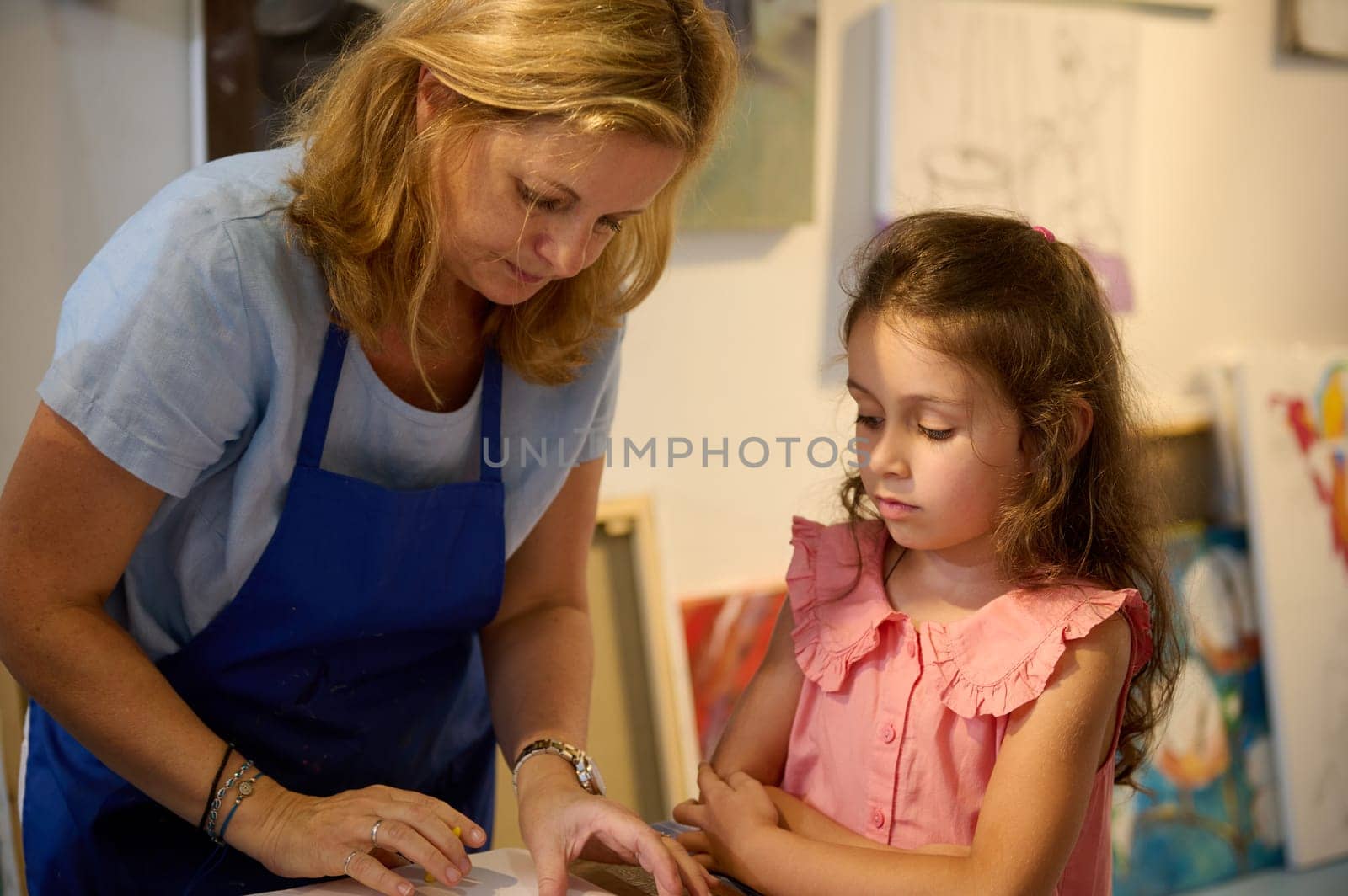 Authentic portrait of an art school student girl and female artist painter teacher during painting lesson. Individual art-class concept. Drawing. Painting. Fine and visual art class concept