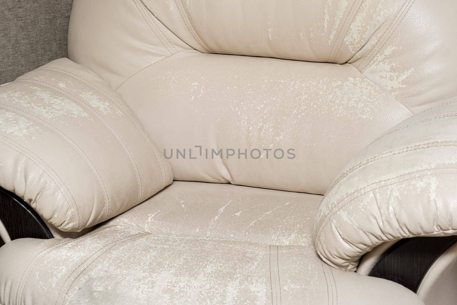 Defects on a white leather sofa. Damaged to leather furniture. by AnatoliiFoto