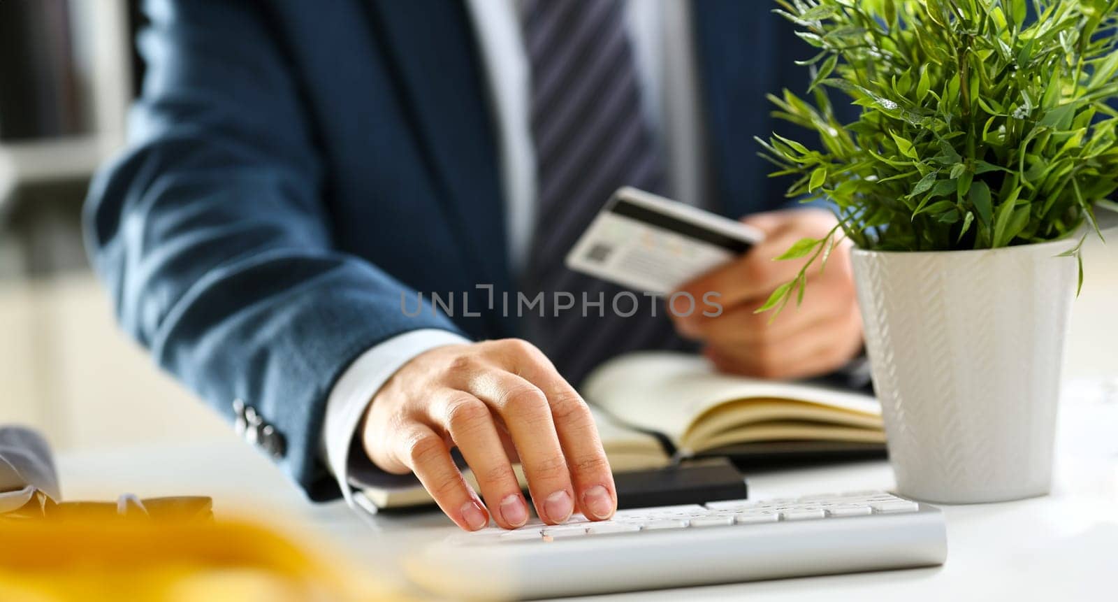 Male arms hold credit card press buttons making transfer closeup. Anti-fraud financial security when entering client discount program number or filling personal credential password login to account