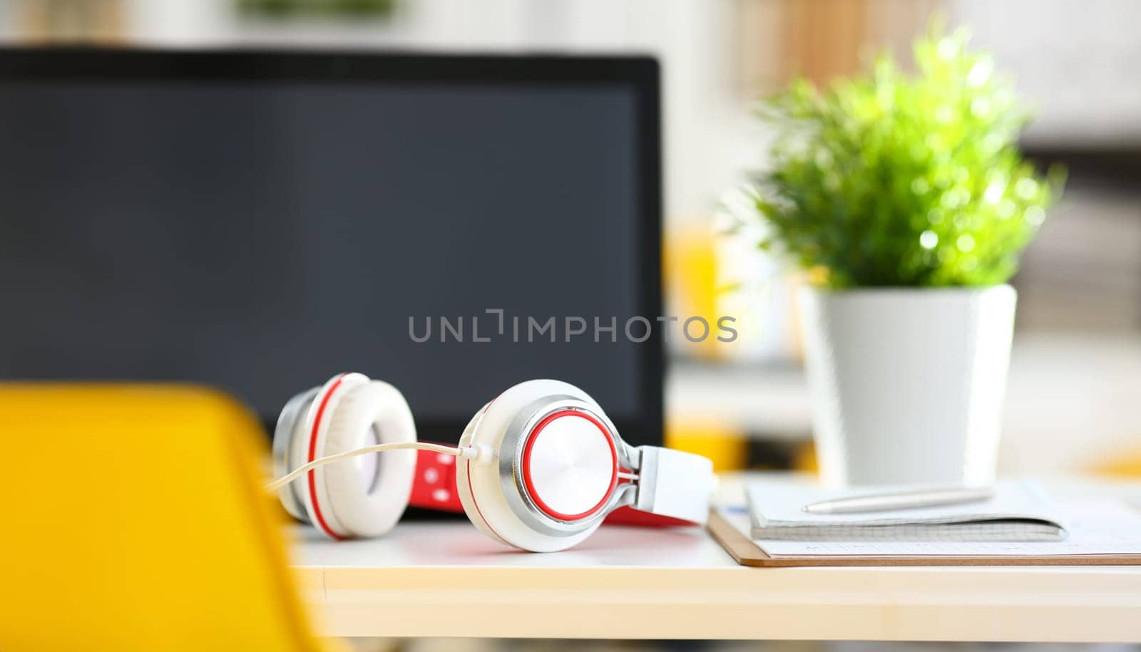 Empty remote office workplace with laptop pc and headset closeup. Receptionist or secretary of contact data center desktop keyboard device desk table ip telephony or callcenter voice message system