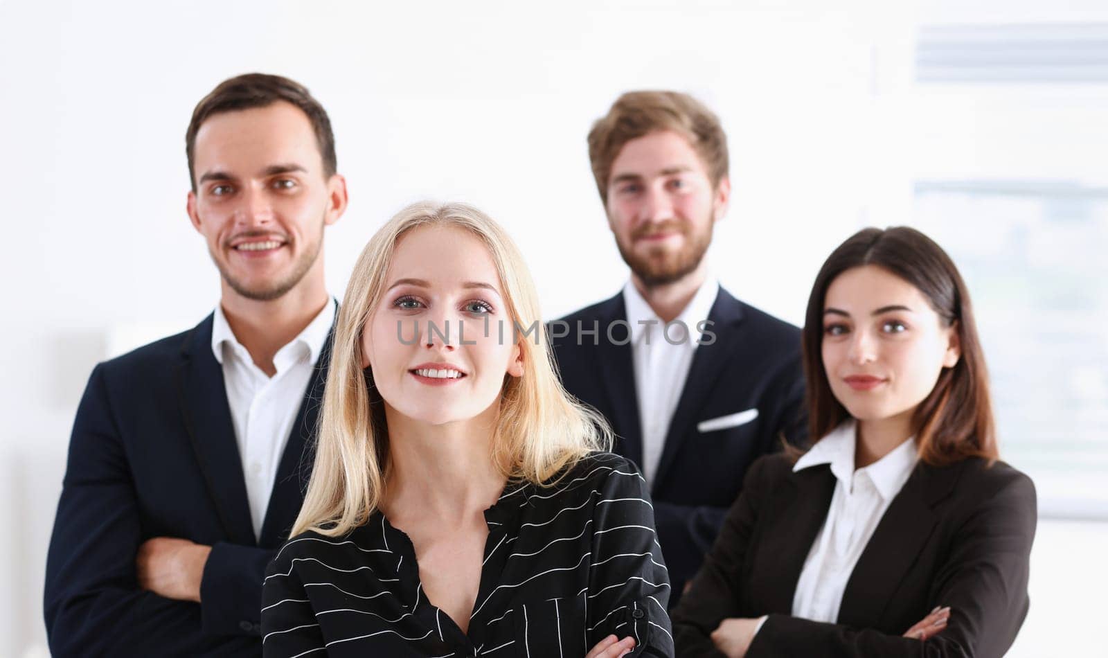 Group of smiling people stand in office by kuprevich
