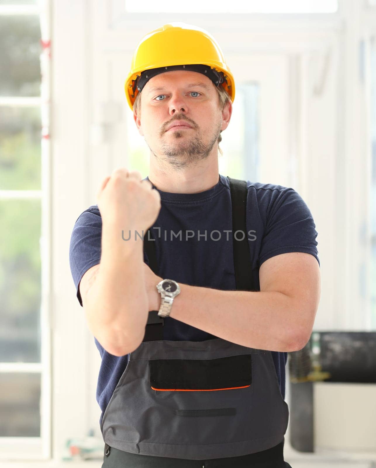 Smiling funny worker in yellow helmet posing. Manual job workplace DIY inspiration improvement fix shop hard hat joinery startup idea industrial education profession career concept