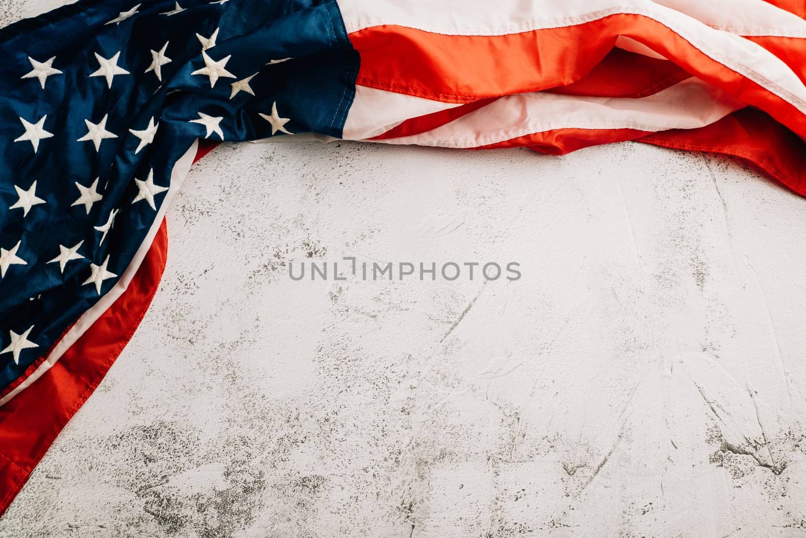 A vintage American flag on Veteran's Day, representing honor, unity, and pride. Stars and stripes symbolize the government's role in patriotic glory. isolated on cement background