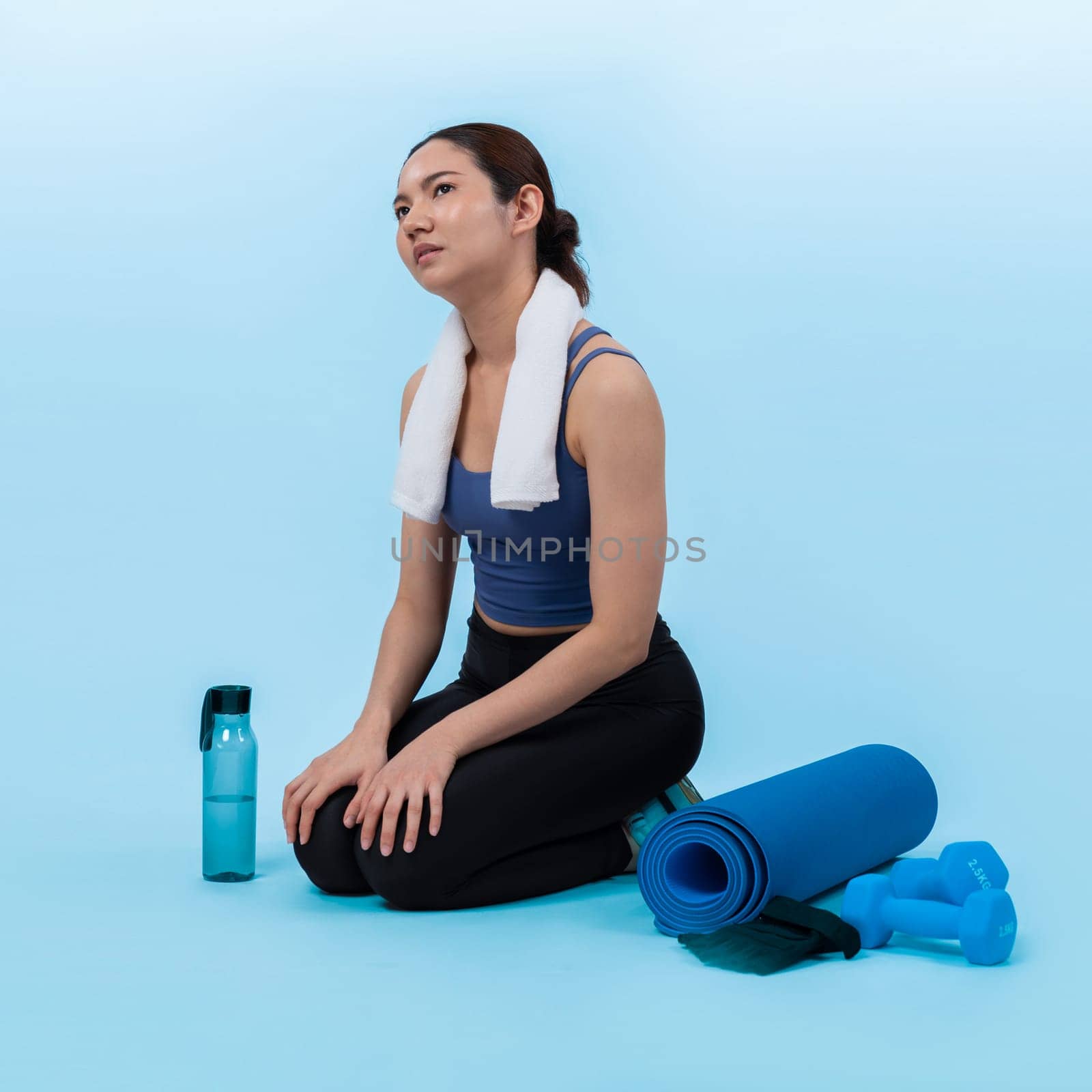 Athletic and sporty asian woman resting after intensive cardio workout training. Healthy exercising and fit body care lifestyle pursuit in studio shot isolated background. Vigorous