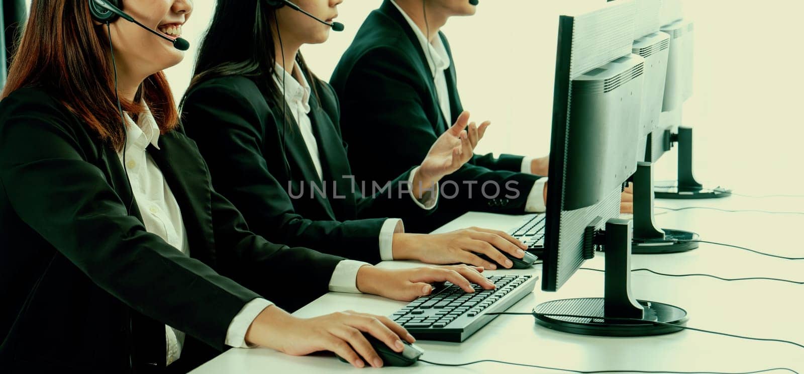 Business people wearing headset working in office to support remote customer or colleague. Call center, telemarketing, customer support agent provide service on telephone video conference oratory call