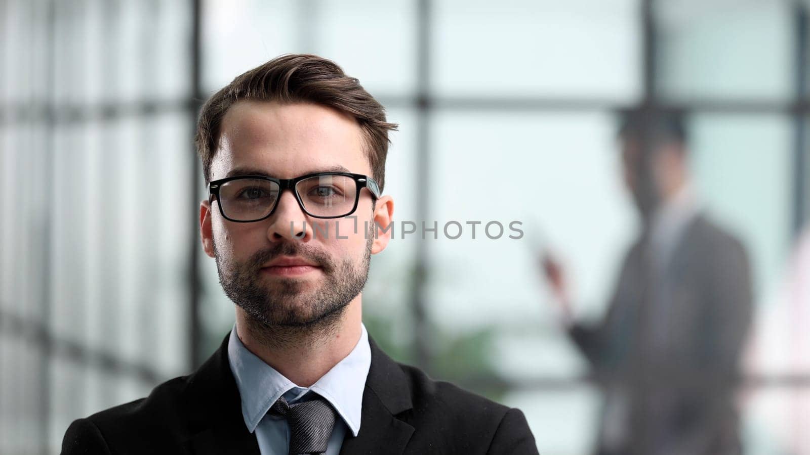 Portrait of handsome young businessman in suit, close-up