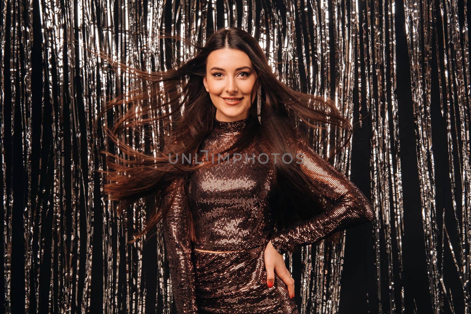 girl in a shiny dress on a silver background of New Year's rain with developing hair by Lobachad