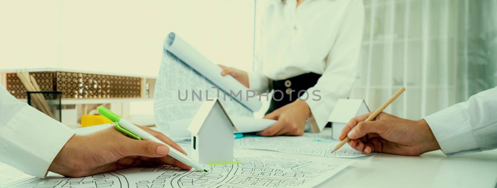 Worker, architect and engineer work on real estate construction project oratory planning with cartography and cadastral map of urban town area to guide to construction developer business plan of city