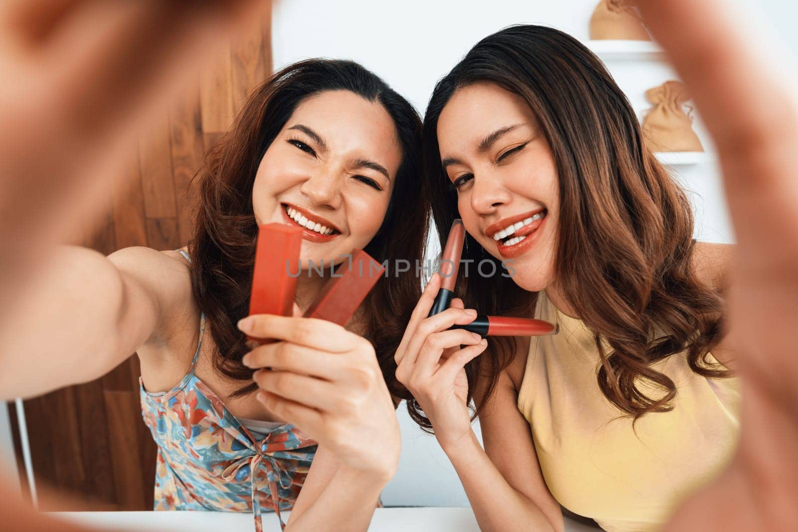 Asian Woman influencer shoot live streaming vlog video review makeup uttermost social media or blog. Happy young girl with cosmetics studio lighting for marketing recording session broadcasting online