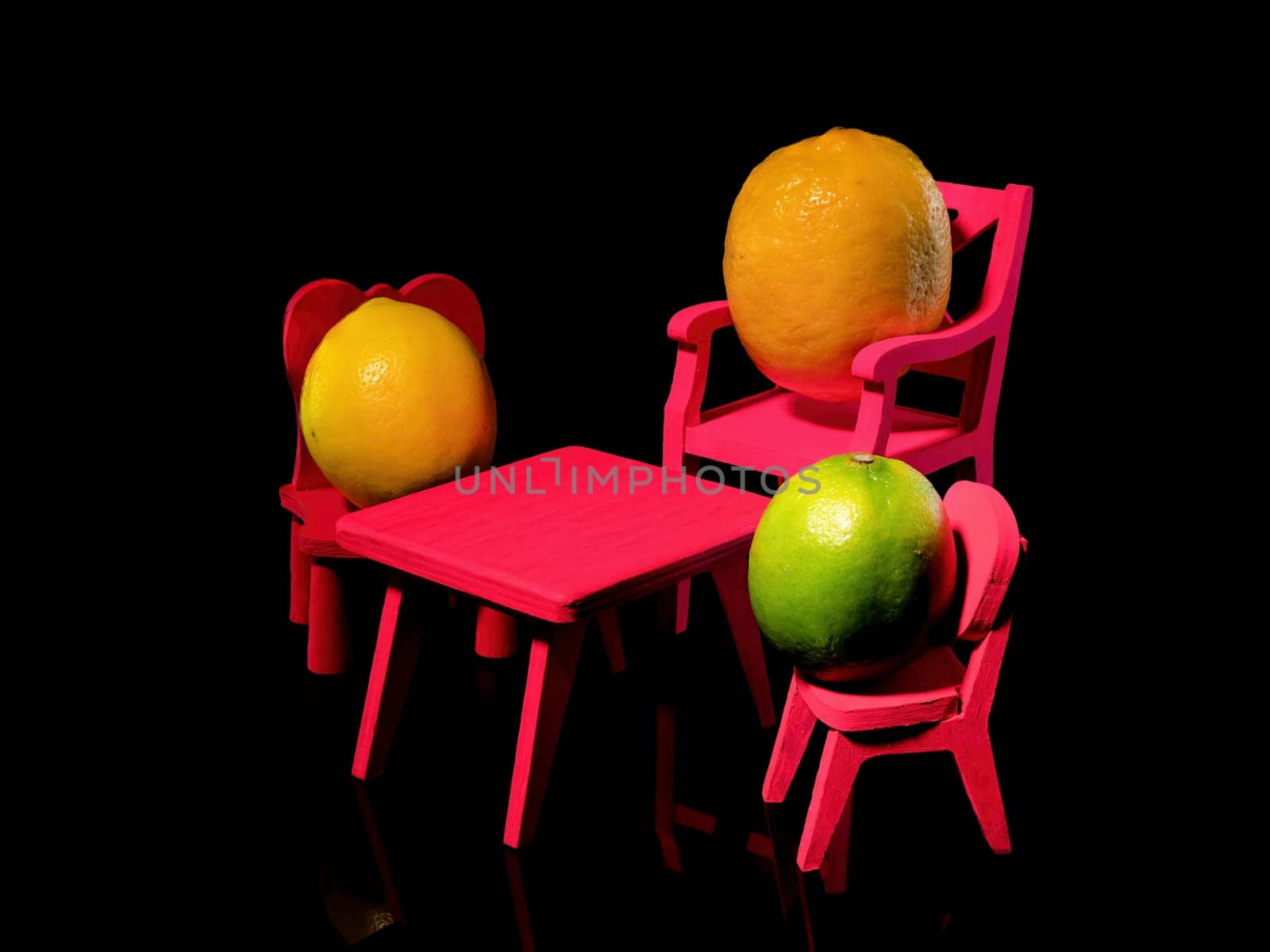 Creative still life with three lemons at the empty table on a black background