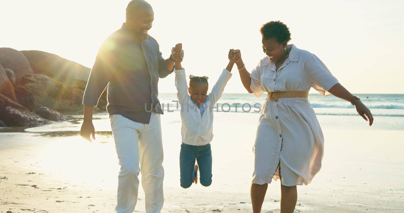 Parents, holding hands and swing child on beach for vacation, holiday and fun game at sunset. Happy family, play and relax together at the sea, ocean and playing on sand with trust, support and care by YuriArcurs