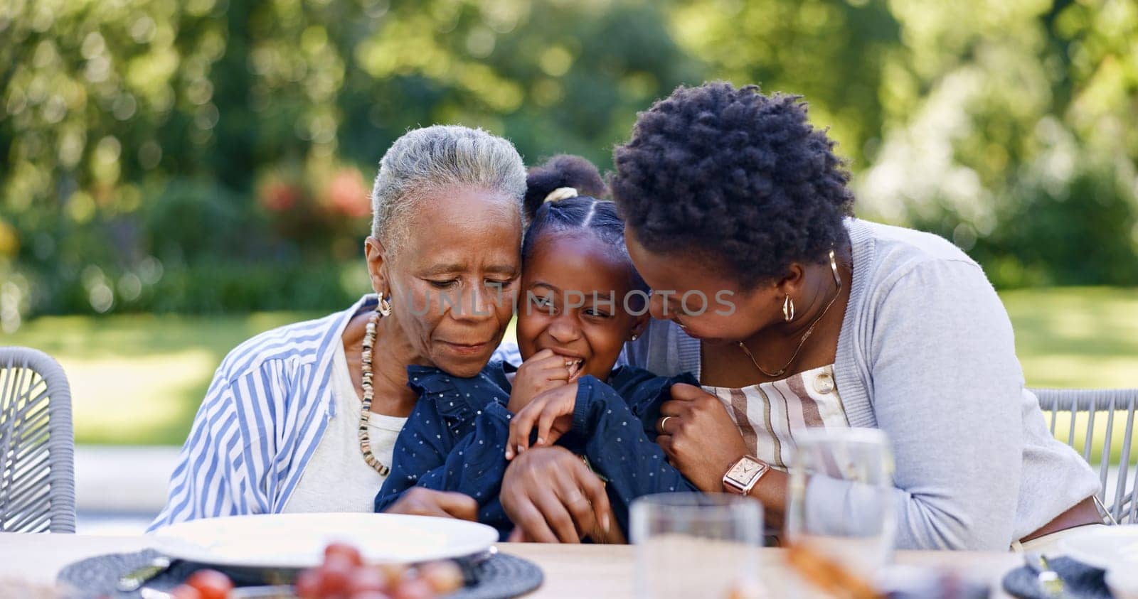 Grandmother, mother and daughter for hug in garden, smile and lunch for relax together with love. Black people, women and child as happy family, gratitude and care bonding for brunch table in park.