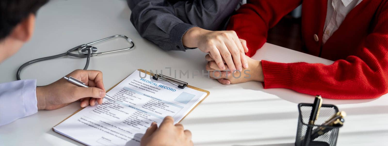 Couple attend fertility or medical consultation with gynecologist at hospital as family planning care for pregnancy. Husband and wife consoling each other through doctor appointment. Panorama Rigid