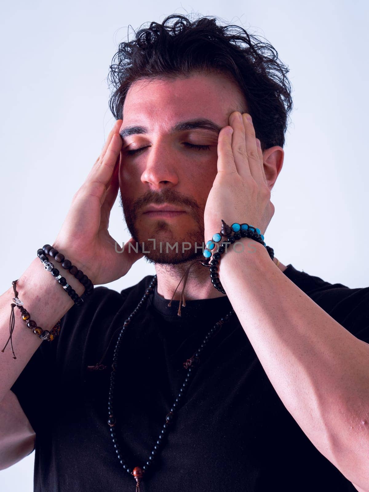 Handsome man holding his head with hands and grimacing in pain for headache, on white by artofphoto