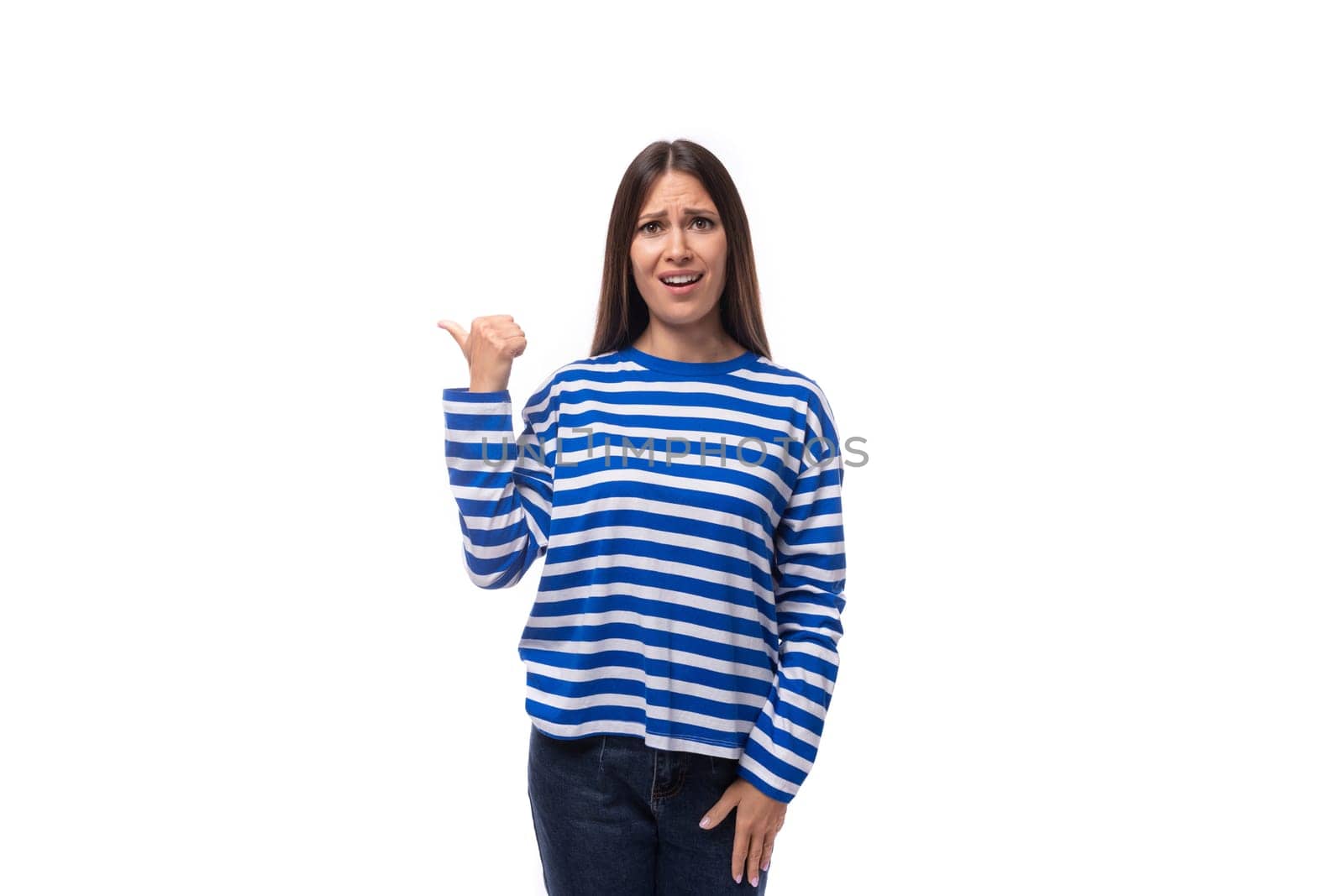 young charming brunette lady with straight hair is dressed in a blue blouse on a white background with copy space by TRMK