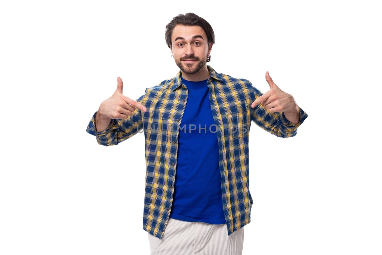 smart brunette macho man with a beard and mustache in a blue shirt on a white background with copy space by TRMK