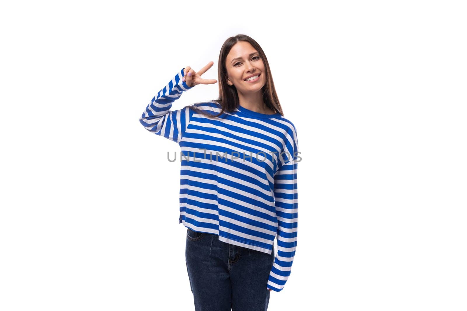 beautiful young brunette woman with long hair in a striped blue blouse on a white background with copy space by TRMK