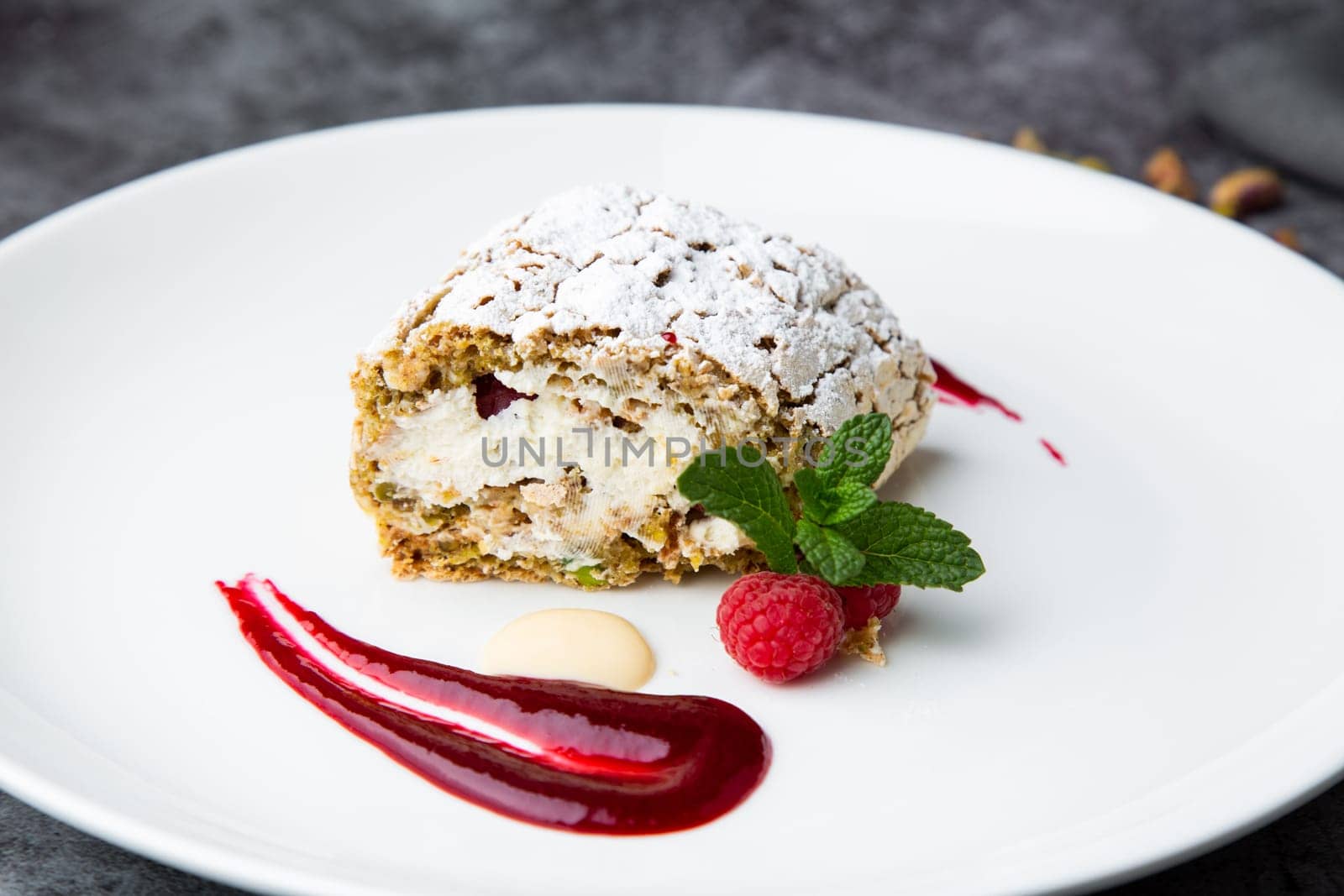 sweet sponge dessert with raspberries and powdered sugar