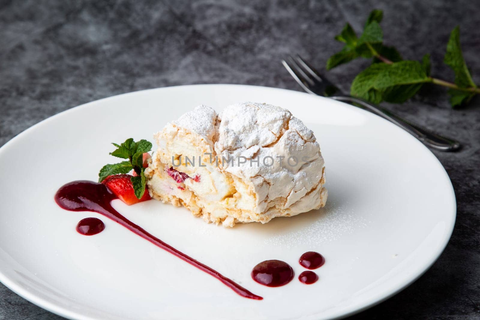 meringue roll with drops of berry jam