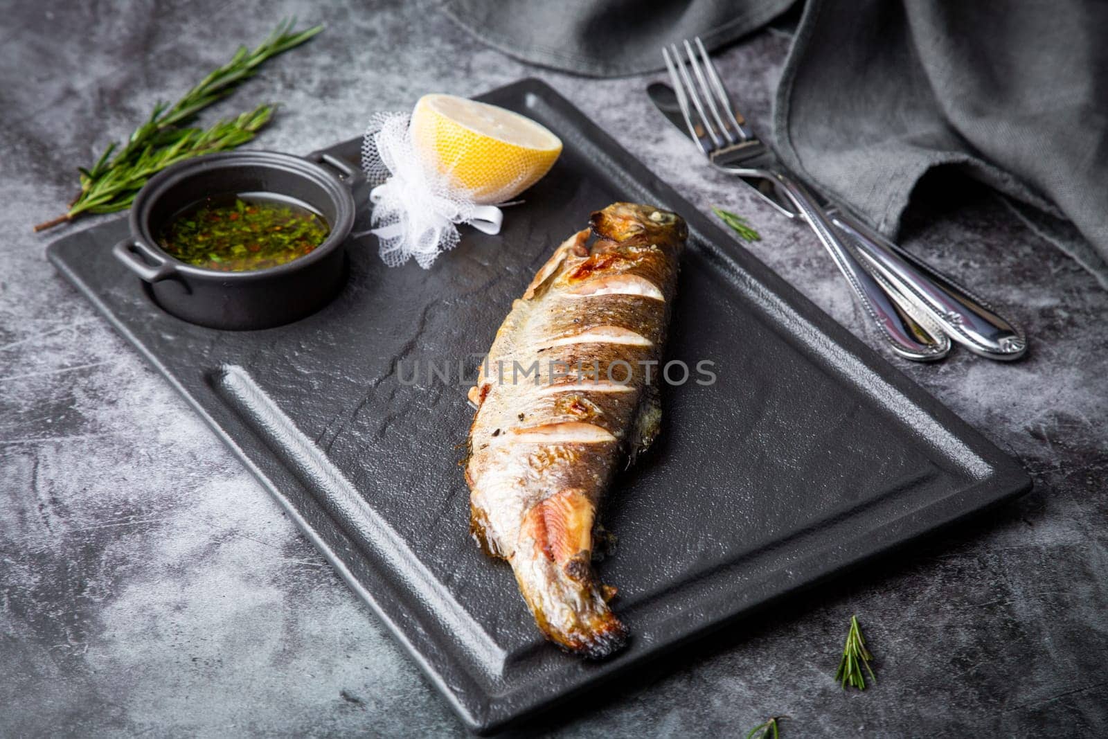 River trout baked in josper with seasonings side view by tewolf