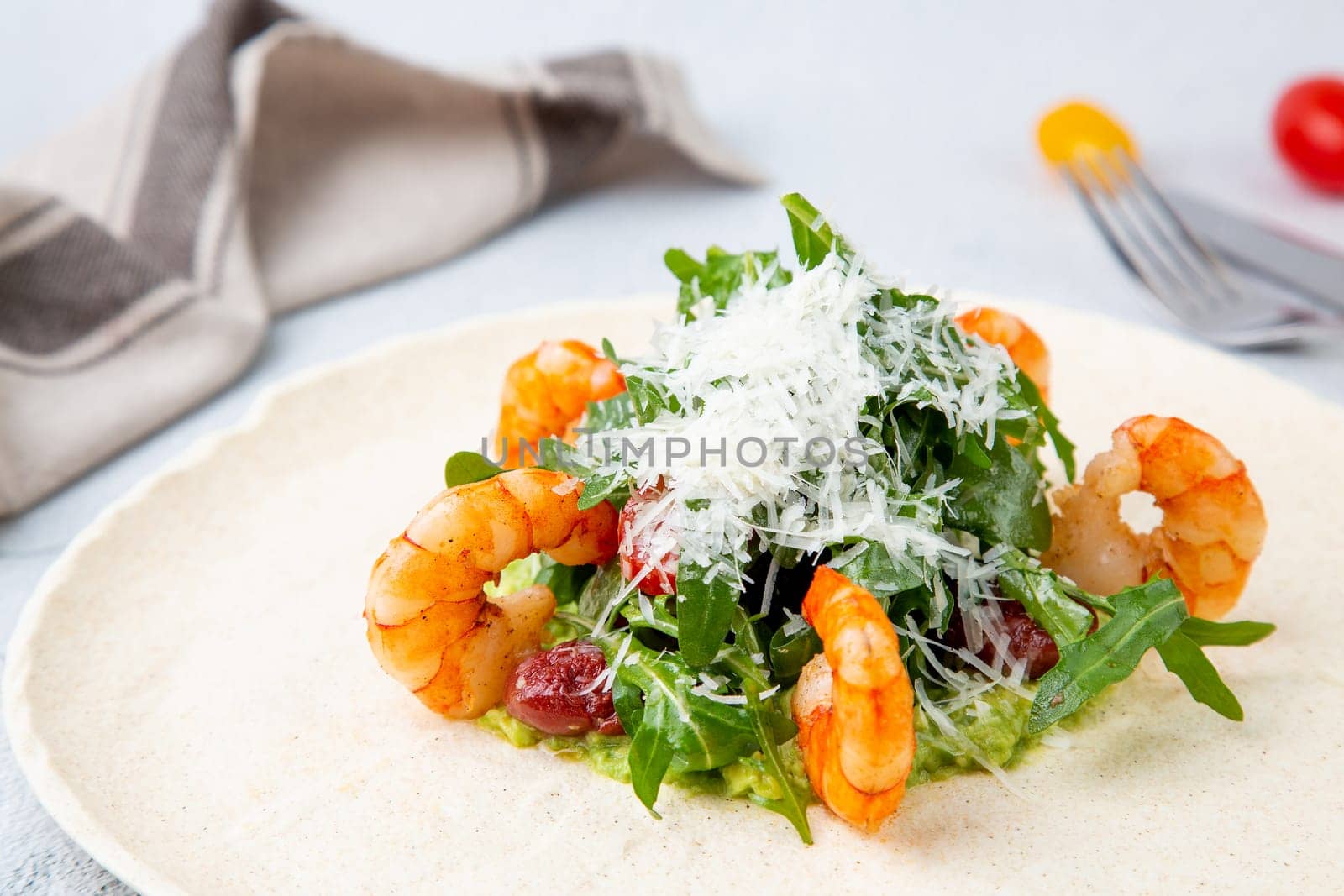 beautifully served shrimp with arugula and grated cheese