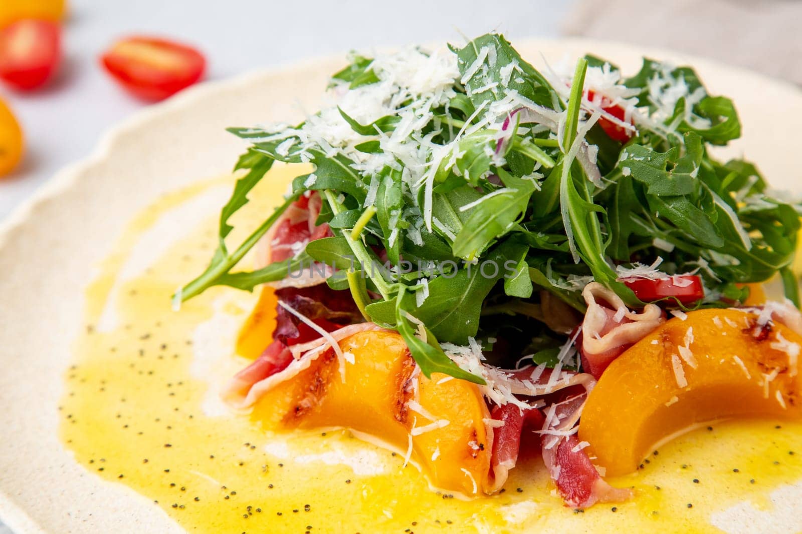 green salad with arugula and lingonberries on a white plate and marble background