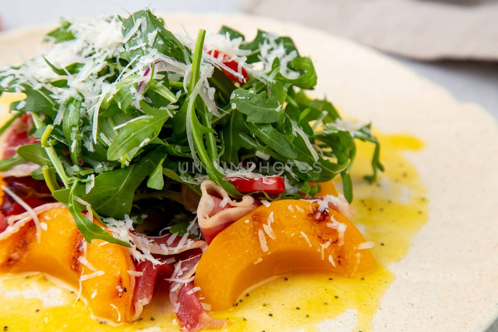 green salad with arugula and lingonberries on a white plate and marble background top view by tewolf