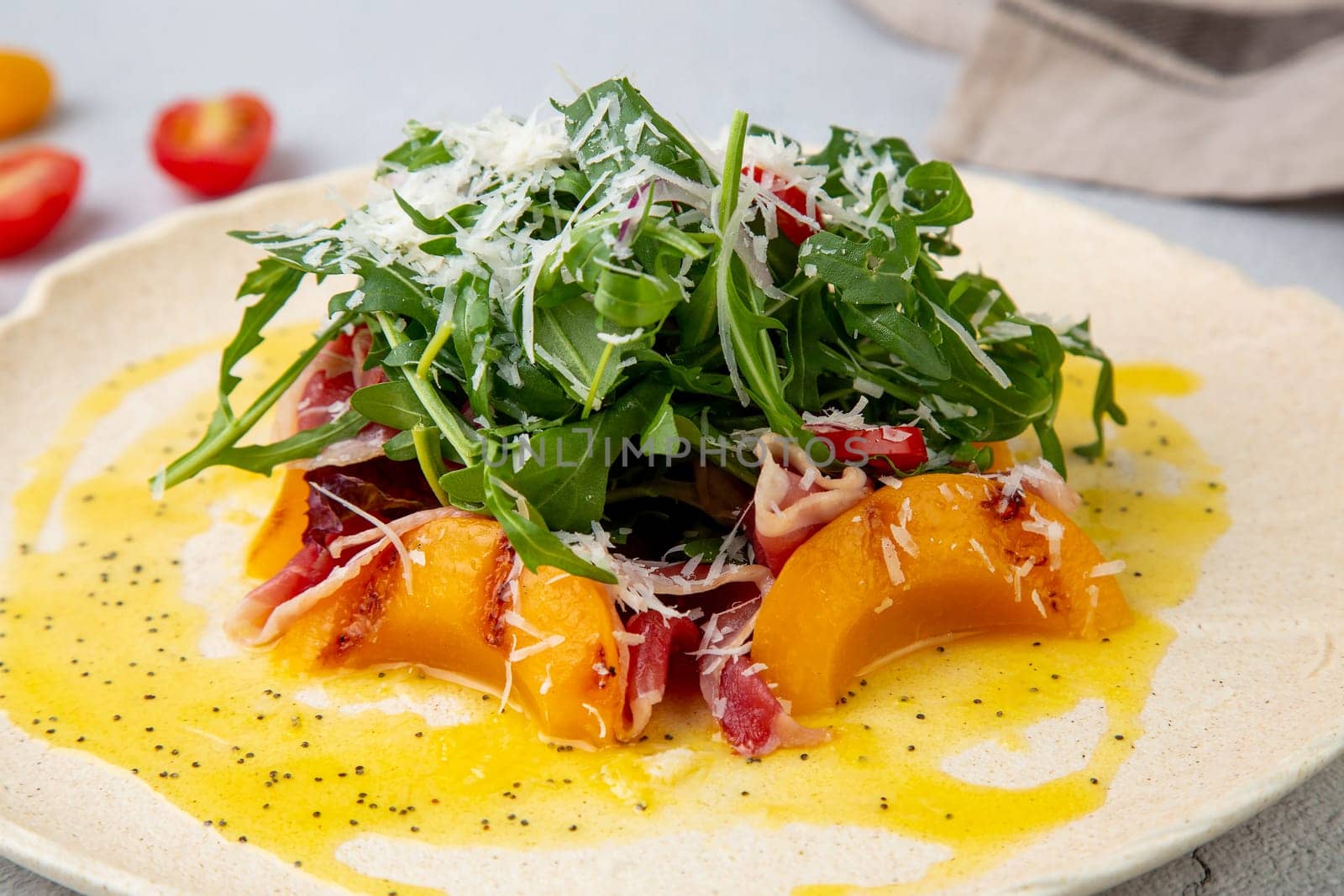 green salad with arugula and lingonberries on a white plate and marble background top view by tewolf