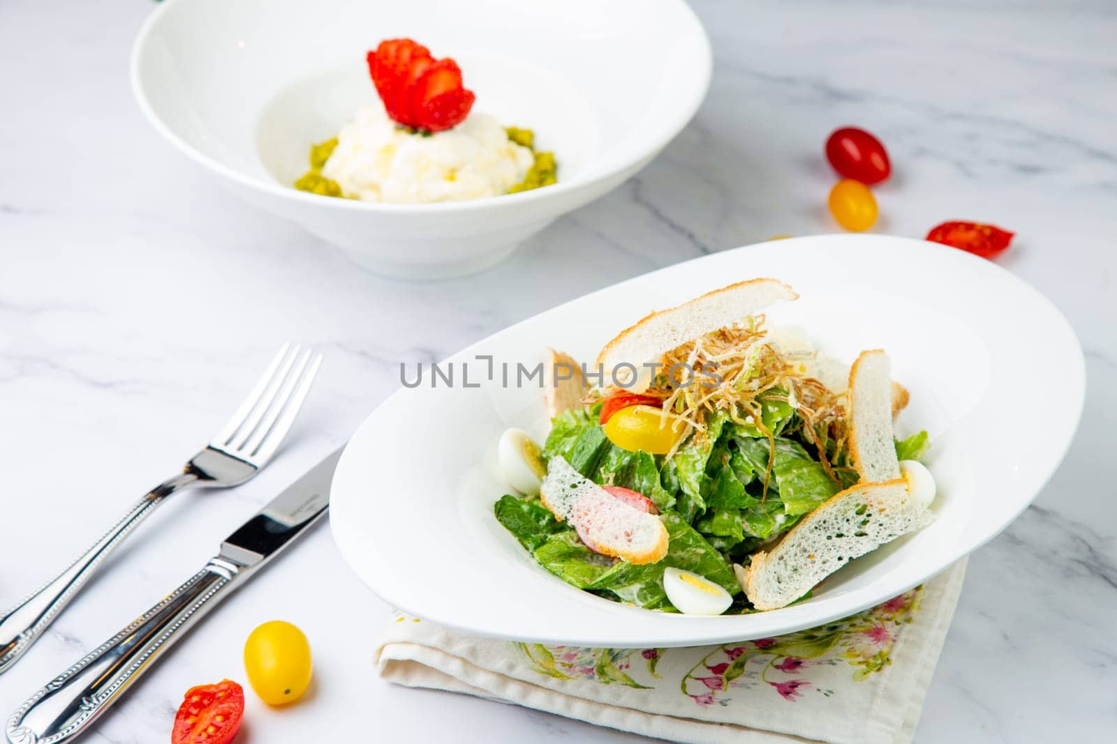 salad with quail eggs, cherry tomatoes, lettuce and breadcrumbs, side view by tewolf