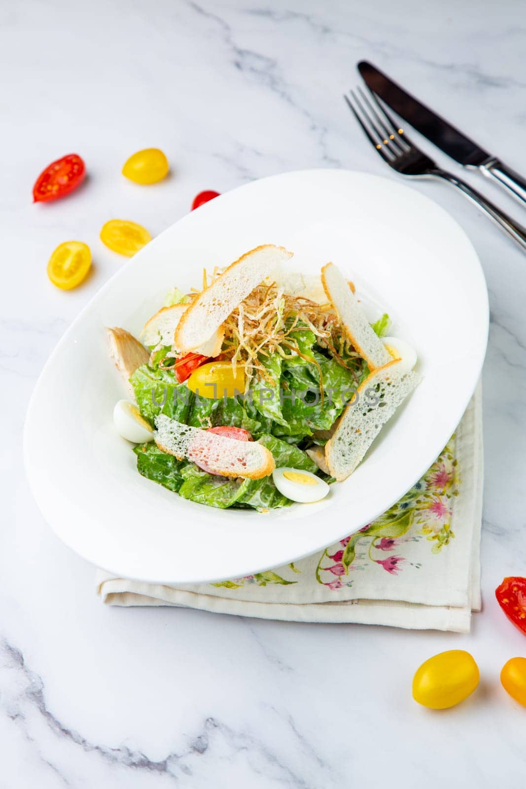 salad with quail eggs, cherry tomatoes, lettuce and breadcrumbs