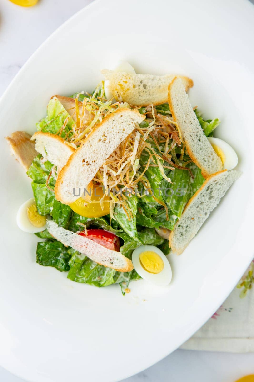 salad with quail eggs, cherry tomatoes, lettuce and breadcrumbs, top view by tewolf