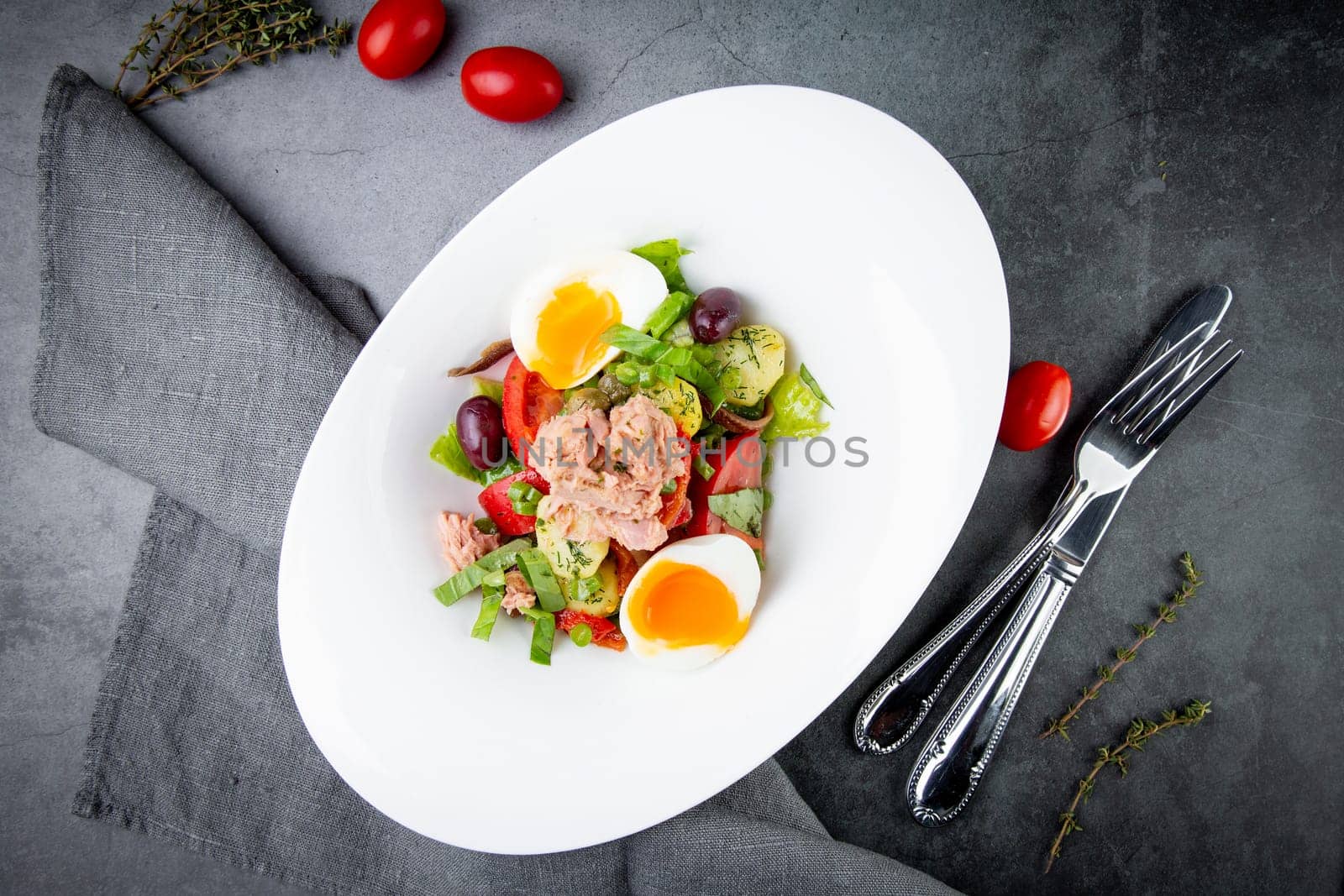 salad with soft-boiled egg, tuna, green onions, boiled potatoes, top view by tewolf