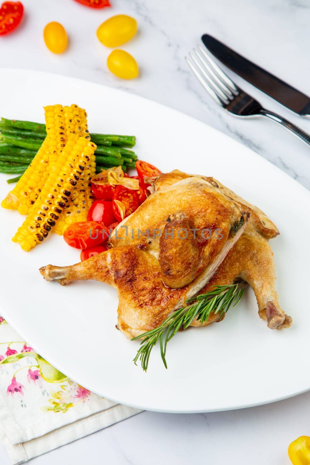 chicken thighs with corn, cherry tomatoes and herbs