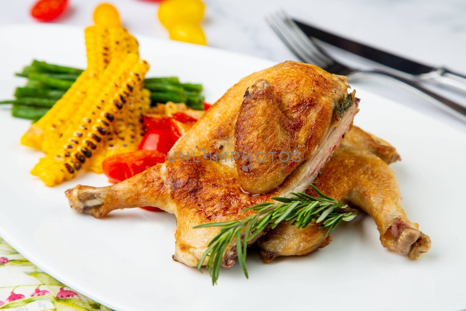 chicken thighs with corn, cherry tomatoes and herbs