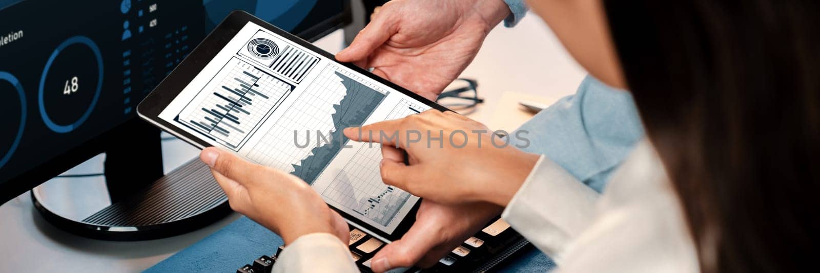 Analyst working on data analysis or BI dashboard on computer monitor. Business team analyzing financial data by Fintech in corporate office for business marketing and strategy planning. Trailblazing