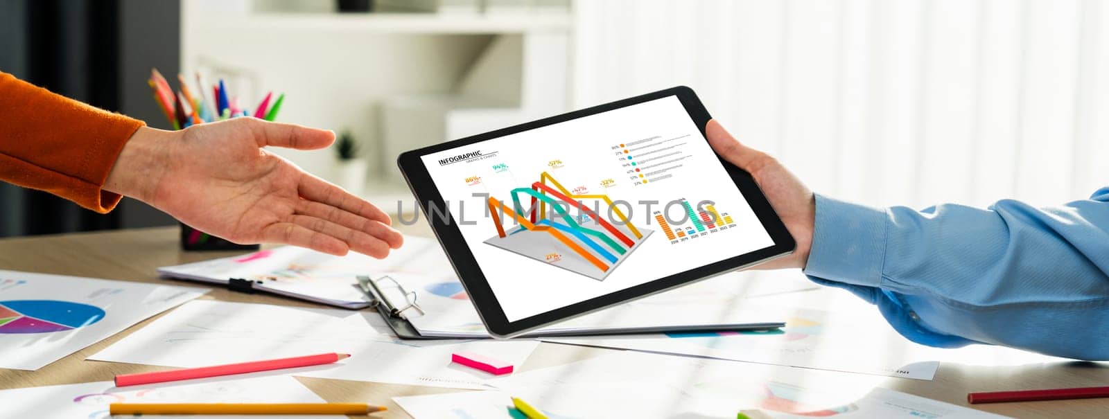 Startup company employee working together using tablet analyzing BI dashboard paper on financial data report and planning strategic marketing for business success in panorama banner. Synergic