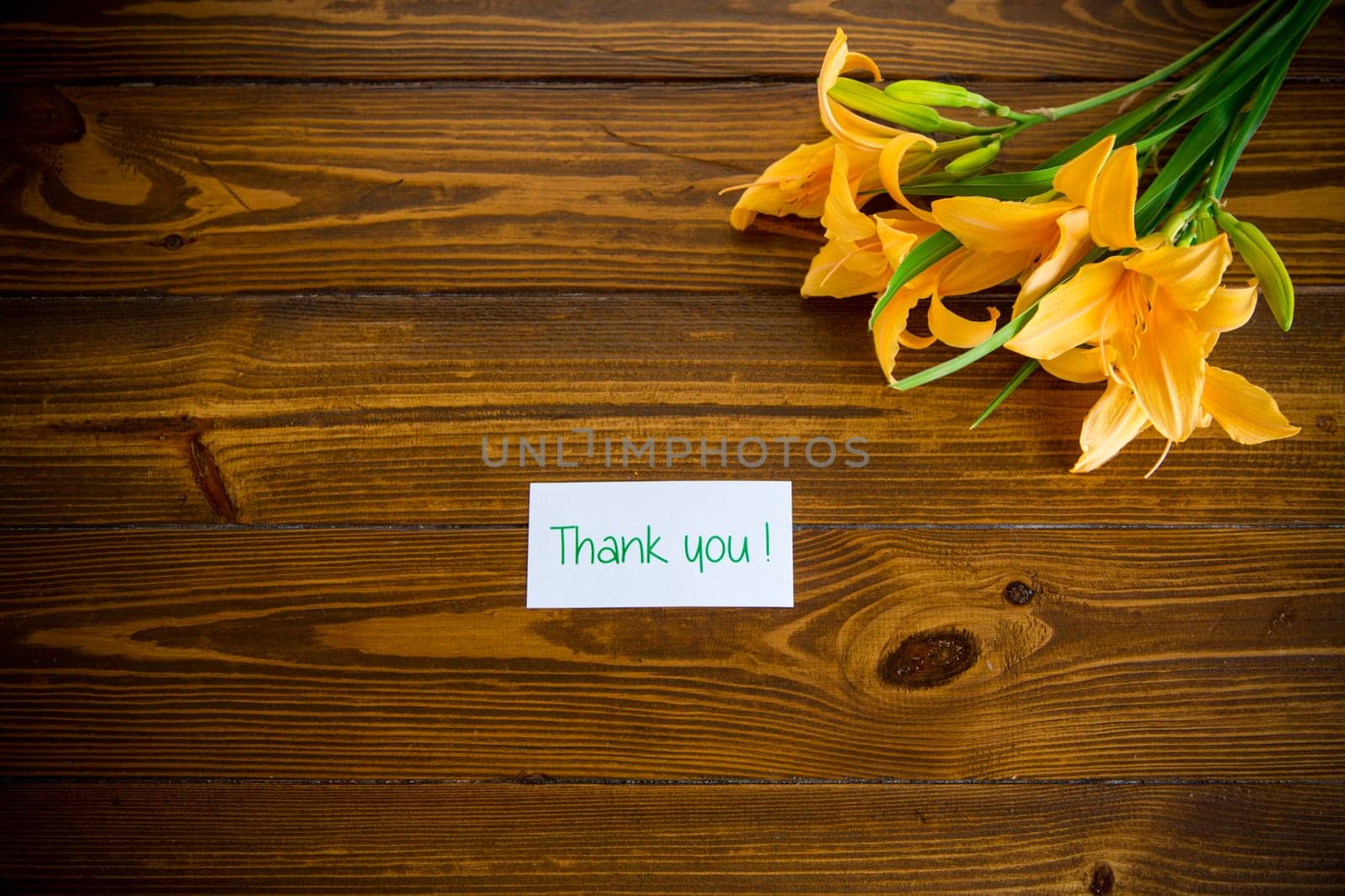 bouquet of beautiful yellow lilies on wooden table by Rawlik