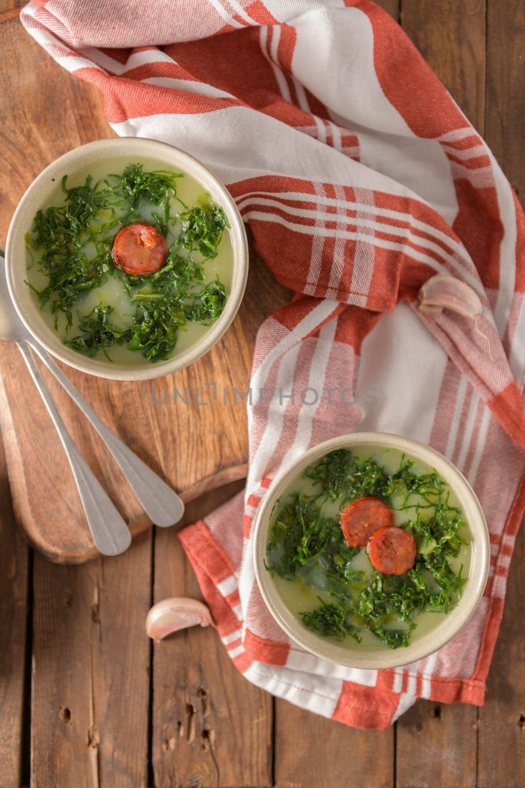 Caldo verde popular soup in Portuguese cuisine. traditional ingredients for caldo verde are potatoes, collard greens , olive oil and salt. Additionally garlic or onion may be added.