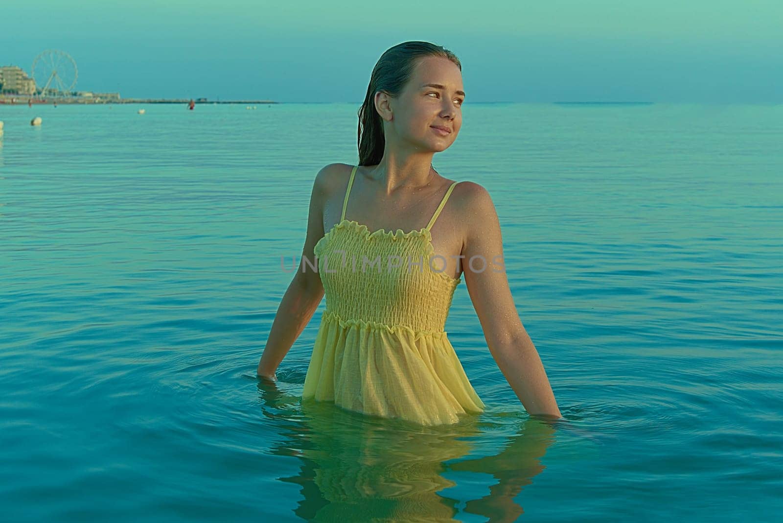 Beautiful sexy stylish Caucasian young woman model on the sea beach at sunrise