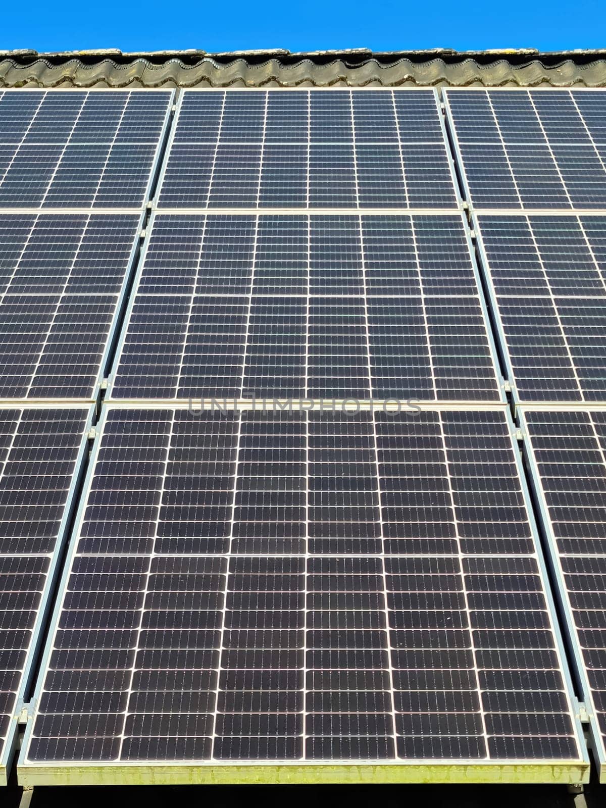 Solar panels producing clean energy on a roof of a residential house by MP_foto71