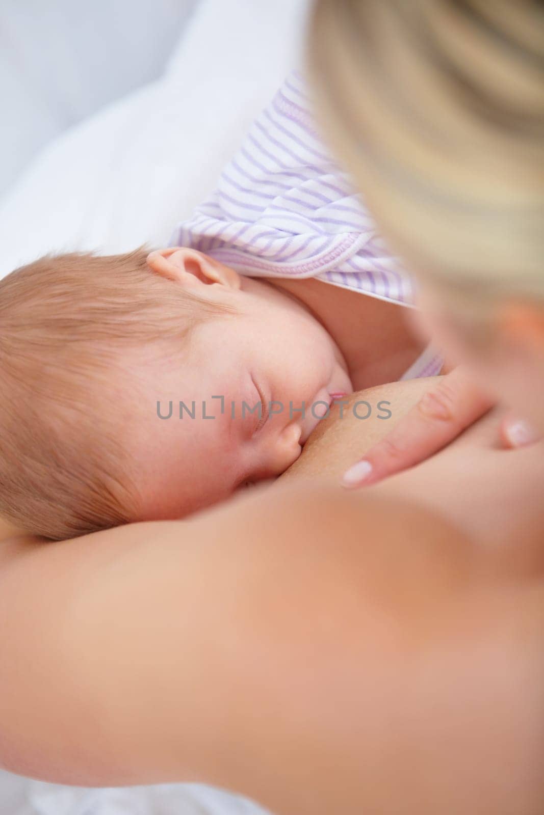 Closeup, woman and baby for breastfeeding in bedroom for hunger, food and nutrition in health. Motherhood, love and bonding in relationship for care, trust or support of growth, development or future by YuriArcurs
