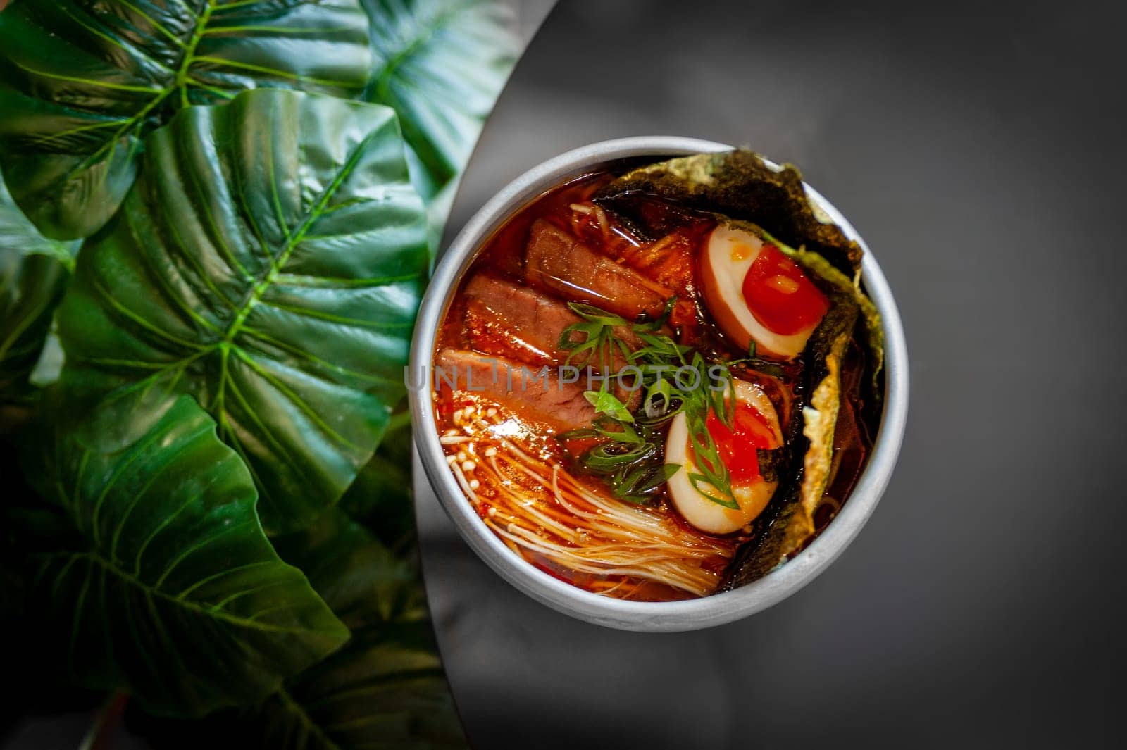 Miso Ramen Asian noodles soup with beef, egg and pak choi cabbage on black background, top view. High quality photo