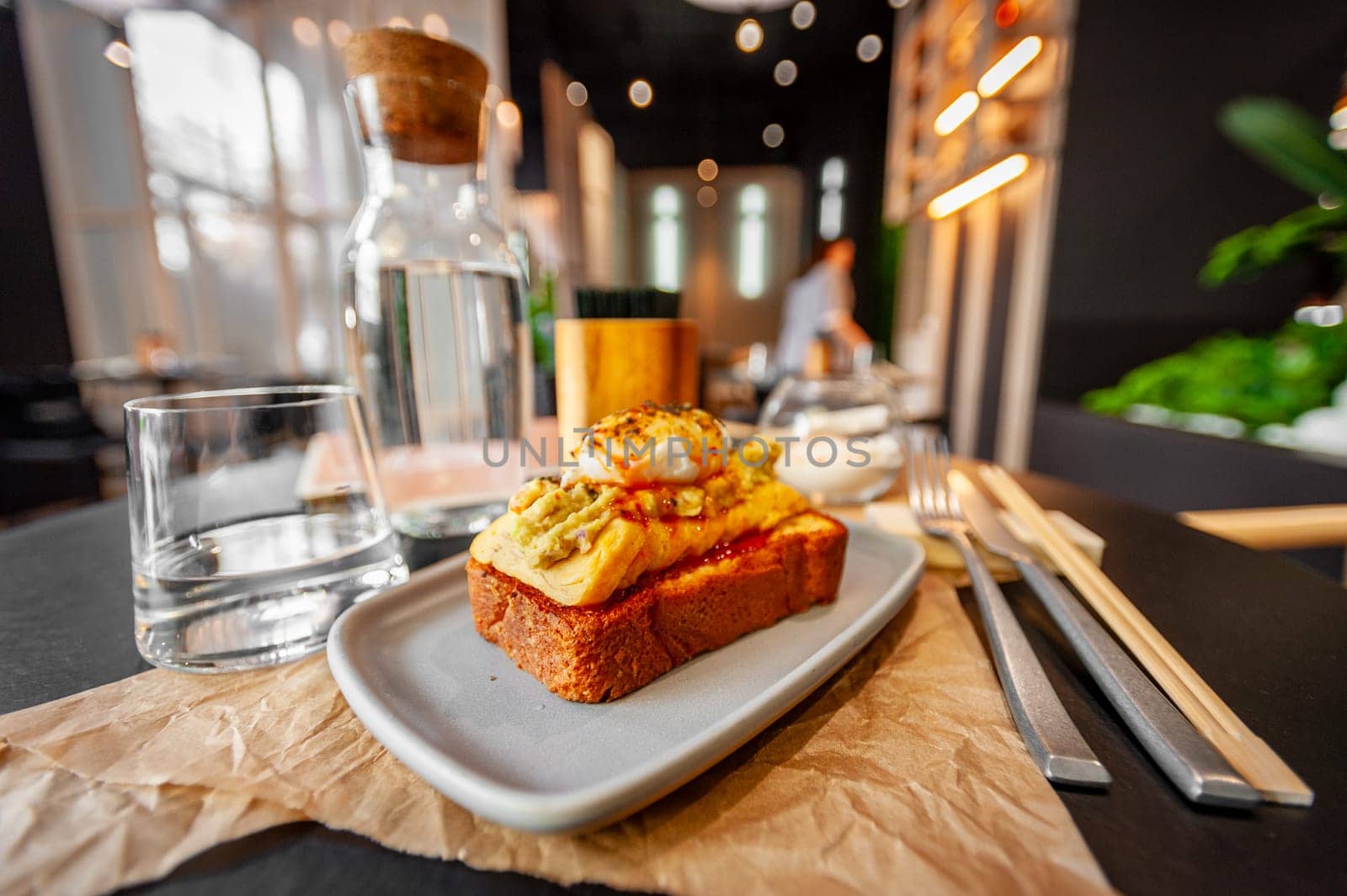 Croque Madame - hot french sandwich with ham, melted cheese, fried egg and sauce with salad. Delicious breakfast. High quality photo