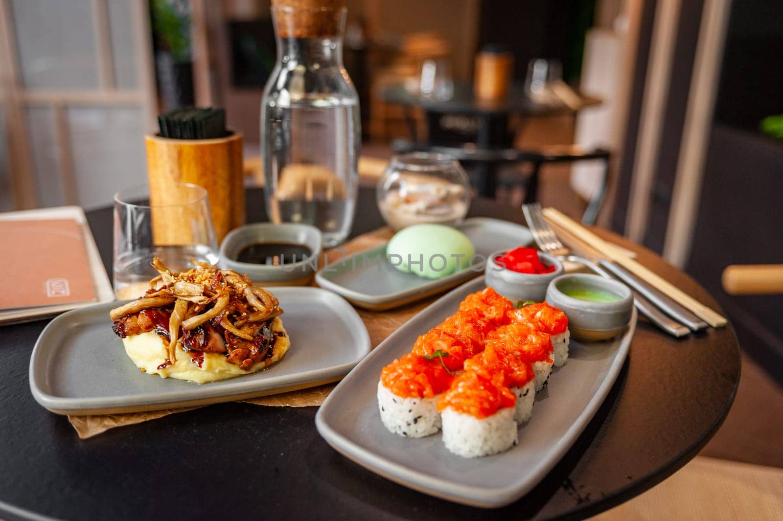 Sushi roll with salmon tartare and sesame seeds on a plate close-up. High quality photo