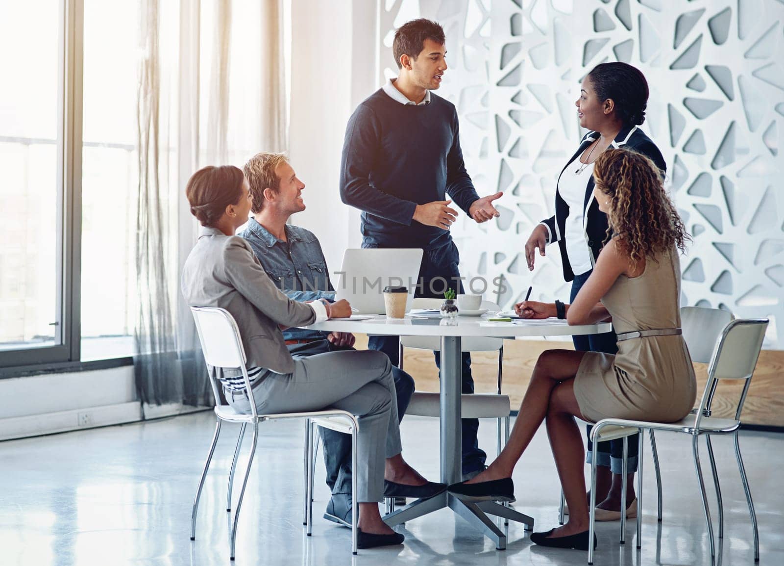 Business people, meeting or discussion in office for planning, collaboration and hand gestures by table. Employees, men or women at corporate workplace with communication and brainstorming with smile.