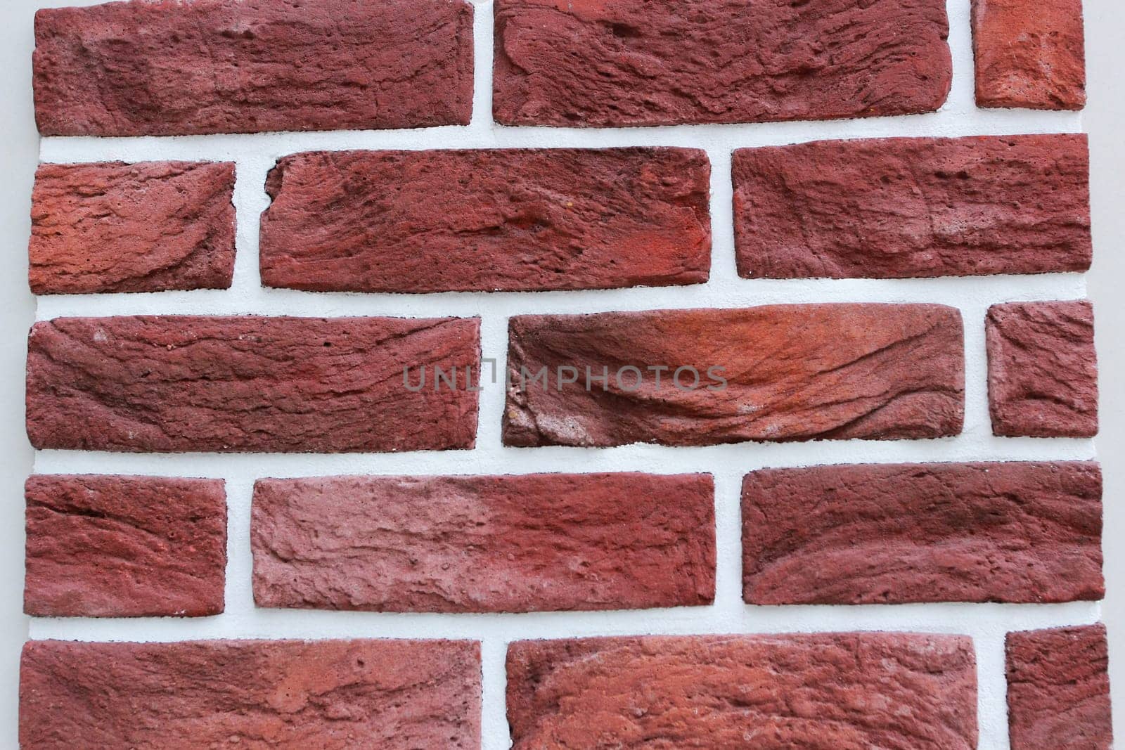 Photo texture red brick and white seams. The texture of the wall. Facing material. Walls of houses.
